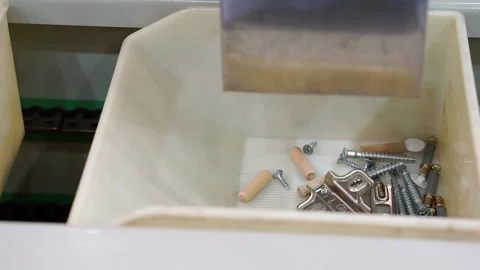 Fragment of the packaging process for small parts of furniture fittings. Stock Footage 143490748