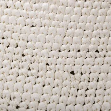 Fragment of patterned dense fabric made of white synthetic thread Foto stock