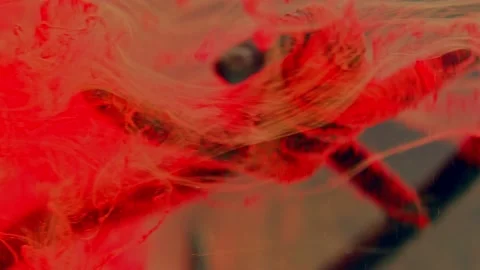 A fragment of rusty barbed wire in a liquid red stream. Stock Footage 193448837