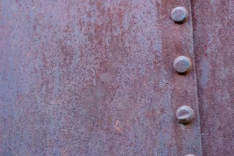 Fragment Rusty riveted hull of an old ship. Stock Photos