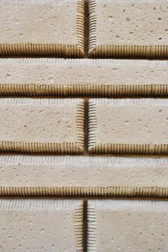 Fragment of a stone wall made of processed stone. Stock Photos