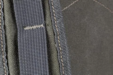 Fragment of a textile backpack. Textured pattern of coarse interwoven threads. Stock Photos