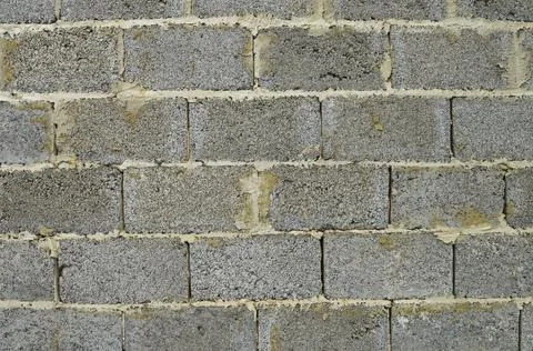 Fragment of a wall of gray rectangular concrete blocks Stock Photos