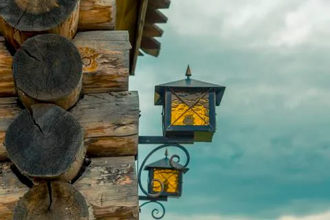 Fragment of wooden log cabin with lanterns Stock Photos
