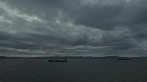 Fragmentary storm clouds rush over the sea and the sea ships. Stock Footage 142846372