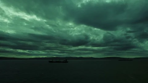 Fragmentary storm clouds rush over the sea and the sea ships. Stock Footage 143041763