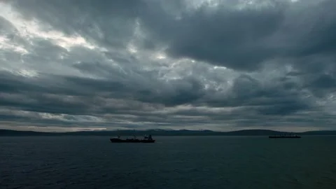 Fragmentary storm clouds rush over the sea and the sea ships. Stock Footage 143292790