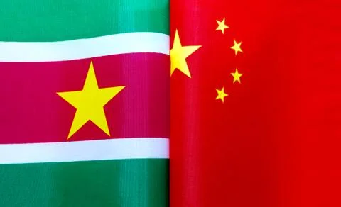 Fragments of the national flags of the Republic of Suriname and China Stock Photos
