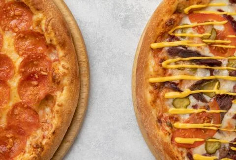 Fragments of two pizzas on the table Foto stock