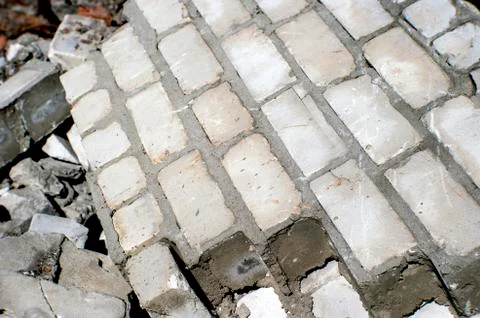 Fragments of a wall of a gray brick at utilization of a brick building Stock-Fotos