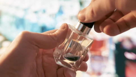 Fragrance Exploration: Man's Hand Testing Luxury Perfume Tester in Upscale Store Stock-Footage 284409309