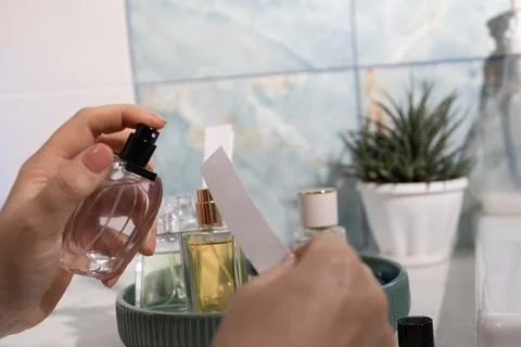 Fragrance Testing in Vanity Setup: Spraying Perfume onto Tester Card Stock Photos