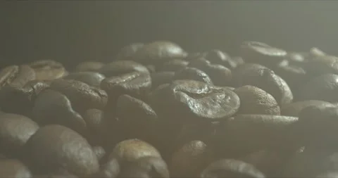 Fragrant coffee beans are roasted smoke comes from coffee beans. Close up of Stock Footage 143171097