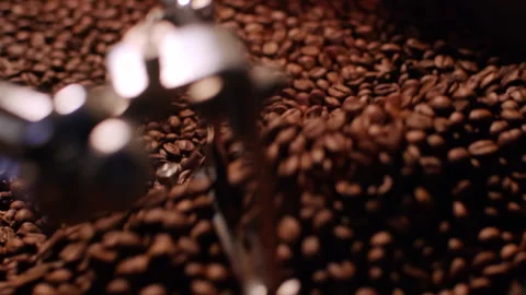 Fragrant coffee beans are roasted in a frying pan, smoke comes from coffee beans Stock Footage 151163610
