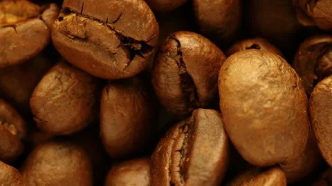 Fragrant coffee beans are roasted in a frying pan, smoke comes from coffee beans Stock Footage 172385817