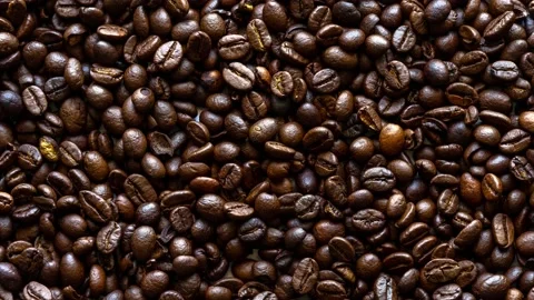 Fragrant coffee beans are roasted in a frying pan, smoke comes from coffee beans 스톡 동영상 172385840
