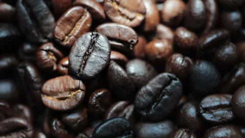 Fragrant coffee beans are roasted. Organic coffee beans. Rotating camera view Video stock 231594202