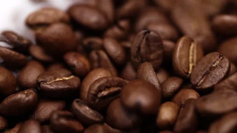Fragrant coffee beans are roasted in a frying pan, smoke comes from coffee beans Stock Footage 260409714