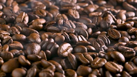 Fragrant coffee beans roasted in a pan with smoke Stock Footage 256302963