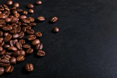 Fragrant coffee beans on rustic tabletop background. Banner copy space. Stock Photos
