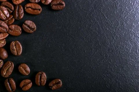 Fragrant coffee beans on rustic tabletop background. Banner copy space. Stock Photos