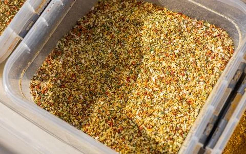 Fragrant colored bulk spices by weight. Loose red, yellow and green spices. C Stock Photos