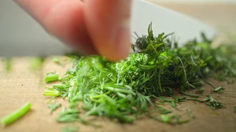 Fragrant dill is cut with a knife. Close-up. Stock Footage 279416544