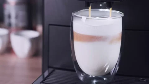 Fragrant latte is prepared in a coffee machine. Coffee drink with milk. Stock Footage 161122194