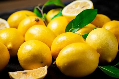 Fragrant lemons with leaves on the table. Stock Photos
