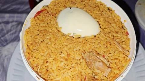 Fragrant mutton bucket biryani served with a boiled egg, packed with aromatic Video stock 346978398