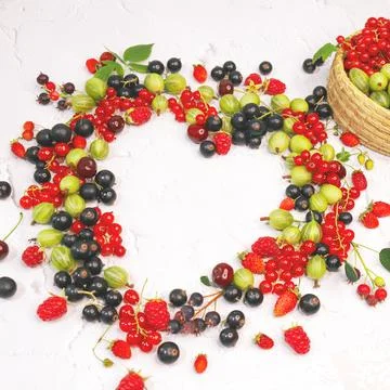 Frame of assorted berries in shape of heart on white background. Copy space. Stock Photos