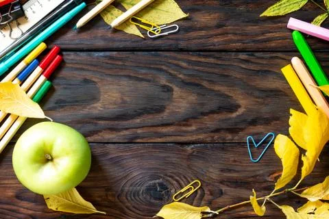 Frame Background Back to school. Table with autumn leaves, apple. Stock Photos
