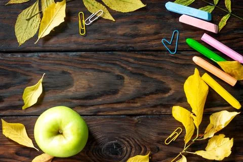 Frame Background Back to school. Table with autumn leaves, apple. Stock Photos
