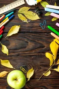 Frame Background Back to school. Table with autumn leaves, apple. Fotos Stock