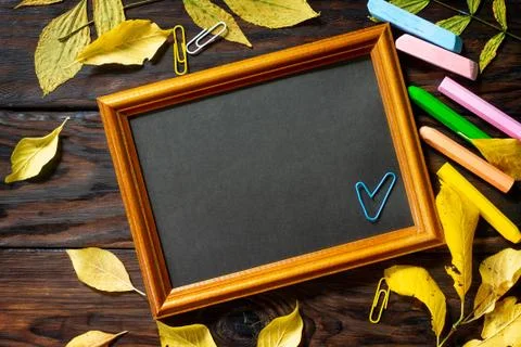 Frame Background Back to school. Table with autumn leaves, apple. Stock Photos