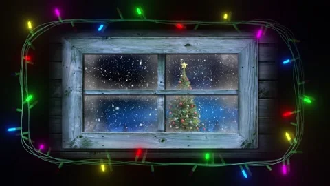 Frame of coloured string lights flashing around window with view of christmas Stock Footage 253457660