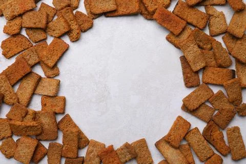 Frame of crispy rusks on light table, flat lay. Space for text 스톡 사진