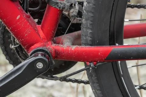 The frame of the e-bike is covered in mud after riding on dirt roads. Stock Photos