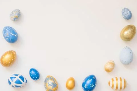 Frame of Easter decorated eggs isolated on white background. Minimal easter 스톡 사진
