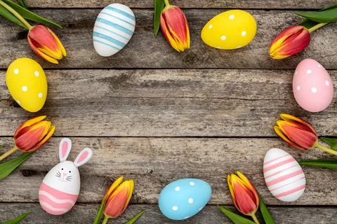 A frame of Easter eggs and tulips Stock Photos
