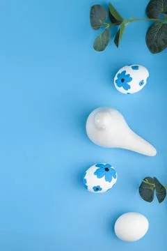 Frame of Easter eggs, decorations and flowers on color background. Stock Photos