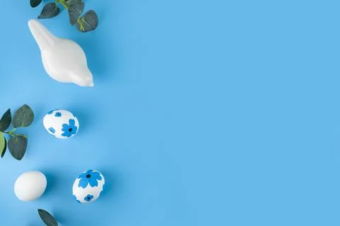 Frame of Easter eggs, decorations and flowers on color background. Stock Photos