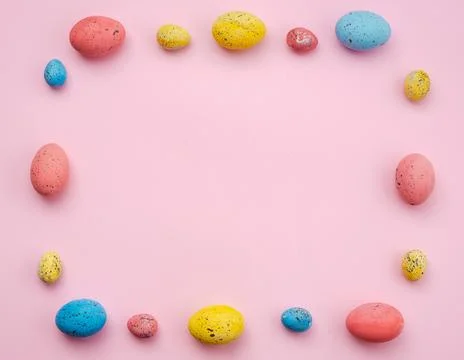 Frame with Easter eggs on a pink background, multi-colored eggs. - Copyspace Stock Photos