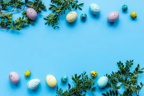 Frame of Easter eggs with spring branches and green leaves. Veiw from above 스톡 사진