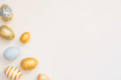 Frame of Easter golden decorated eggs in solated on white background. Minimal 스톡 사진