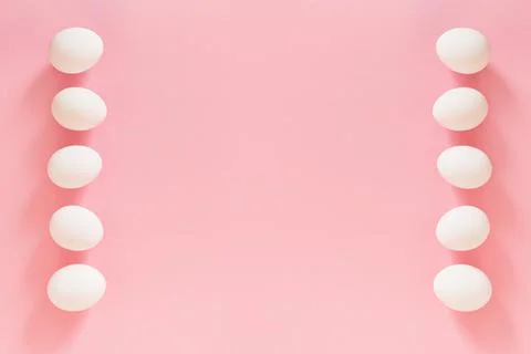 Frame of Easter white natural eggs set isolated on pastel pink background Stock Photos