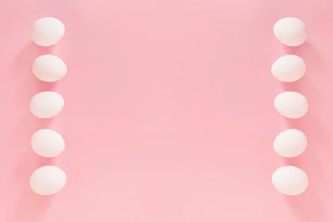 Frame of Easter white natural eggs set isolated on pastel pink background Stock Photos