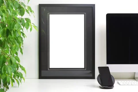 Frame with empty black outlines to customize placed on a modern desk Stock Photos