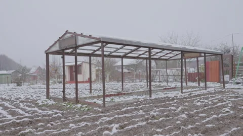 Frame of empty greenhouse in rural backyard in cold winter season on farmland Stock Footage 260245884