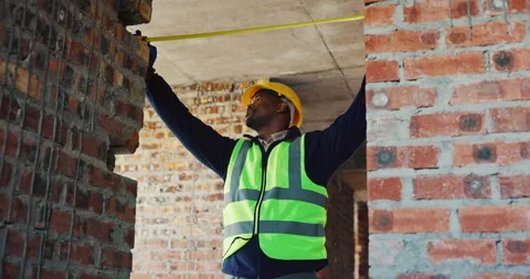 Frame, engineer and tape measure at construction site for precision, dimension Stock Footage 336778879